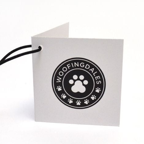 Silk hang tags with elegant lamination, showcasing sophisticated branding and design, complete with eyelets for secure attachment, emphasizing luxury and quality in retail clothing labels and product tags.