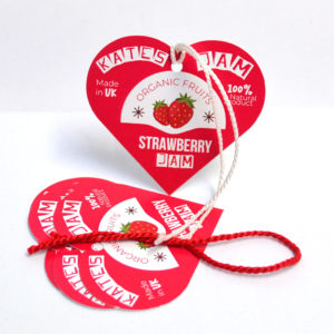 Silk hang tags with elegant lamination, showcasing sophisticated branding and design, complete with eyelets for secure attachment, emphasizing luxury and quality in retail clothing labels and product tags.